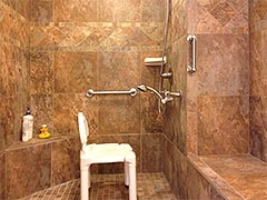 Spaciousness and safety are part of this barrier-free accessible shower as well as beautiful custom tile work
